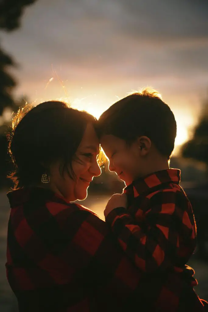 Woman with Her Little Son in Arms Wearing Red Flannel Shirts